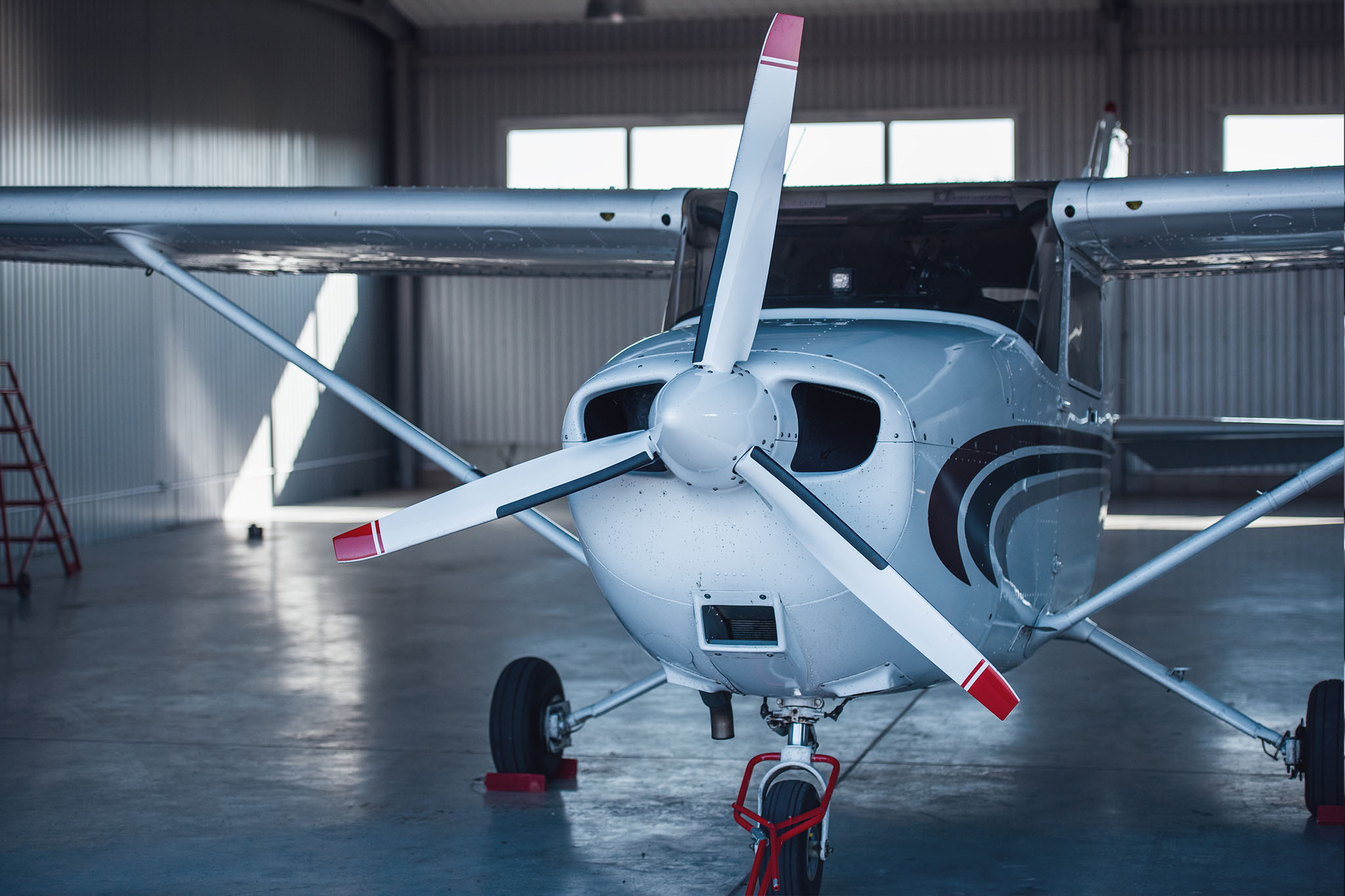 small aircraft parked in a hangar, prepared for dry ice blasting maintenance